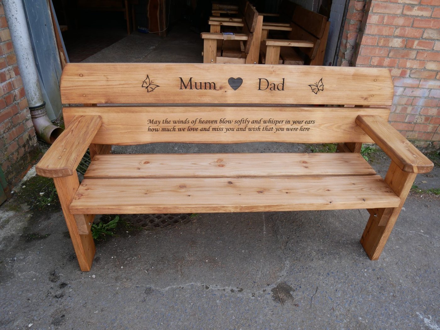 Memorial bench carved for Mum and Dad with butterflies either side
